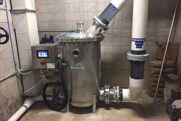 A BSG 30 Commercial pool filtration system is shown inside a grey cinderblock utility room.
